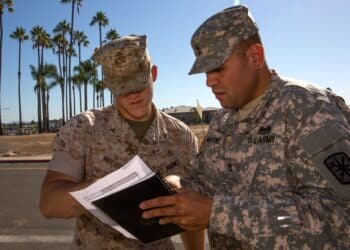 Army Sgt. 1st Class John Martinez, the oncoming course chief with 343rd Training Squadron out of Lackland Air Force Base, Texas, answers questions from Lance Cpl.