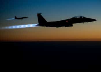 A pair of U.S. Air Force F-15E Strike Eagles fly over northern Iraq early in the morning of Sept. 23, 2014, after conducting airstrikes in Syria. These aircraft were part of a large coalition strike package that was the first to strike ISIL targets in Syria. (U.S. Air Force photo by Senior Airman Matthew Bruch/Released)