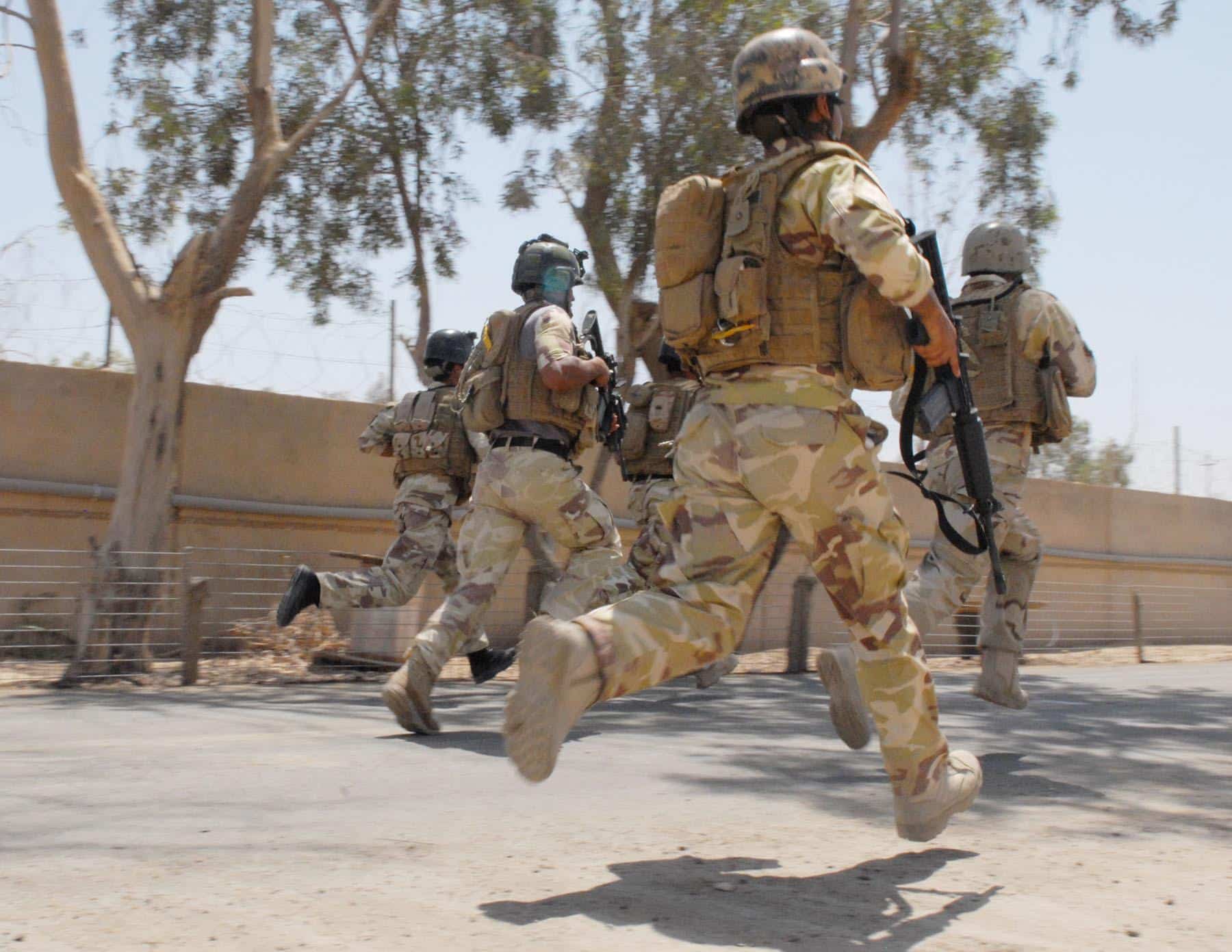 Iraqi Special Operations Forces soldiers in full combat gear sprint for approximately a quarter of a mile during the Special Forces Challenge that took place on a military base in the Baghdad area on June 2. The average Soldier carries about 60 pounds during routine patrols.