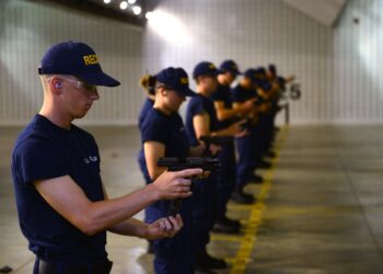 Seaman Recruit Martin Bunn slips a magazine into the Coast Guard's standard issue Sig Sauer P229 .40-caliber during a live-fire exercise at the FAA Technical Center in Galloway, N.J., July 1, 2015. Bunn and the rest of recruit company Lima 191 were transported via bus from the Coast Guard Training Center to the FAA facility to utilize their indoor range. (U.S. Coast Guard photo by Chief Warrant Officer John Edwards)
