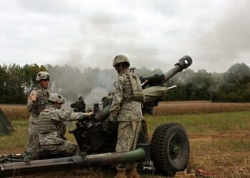 (Far Left) Sgt. James Bartoszek with Battery B, 1st Battalion, 320th Field Artillery Regiment, 2nd Brigade Combat Team, 101st Airborne Division (Air Assault), yells the command ?fire? during the brigade?s combined arms Walk and Shoot exercise Oct. 5. Artillerymen remain a vital component in accurately and quickly defeating, neutralizing and suppressing the enemy.