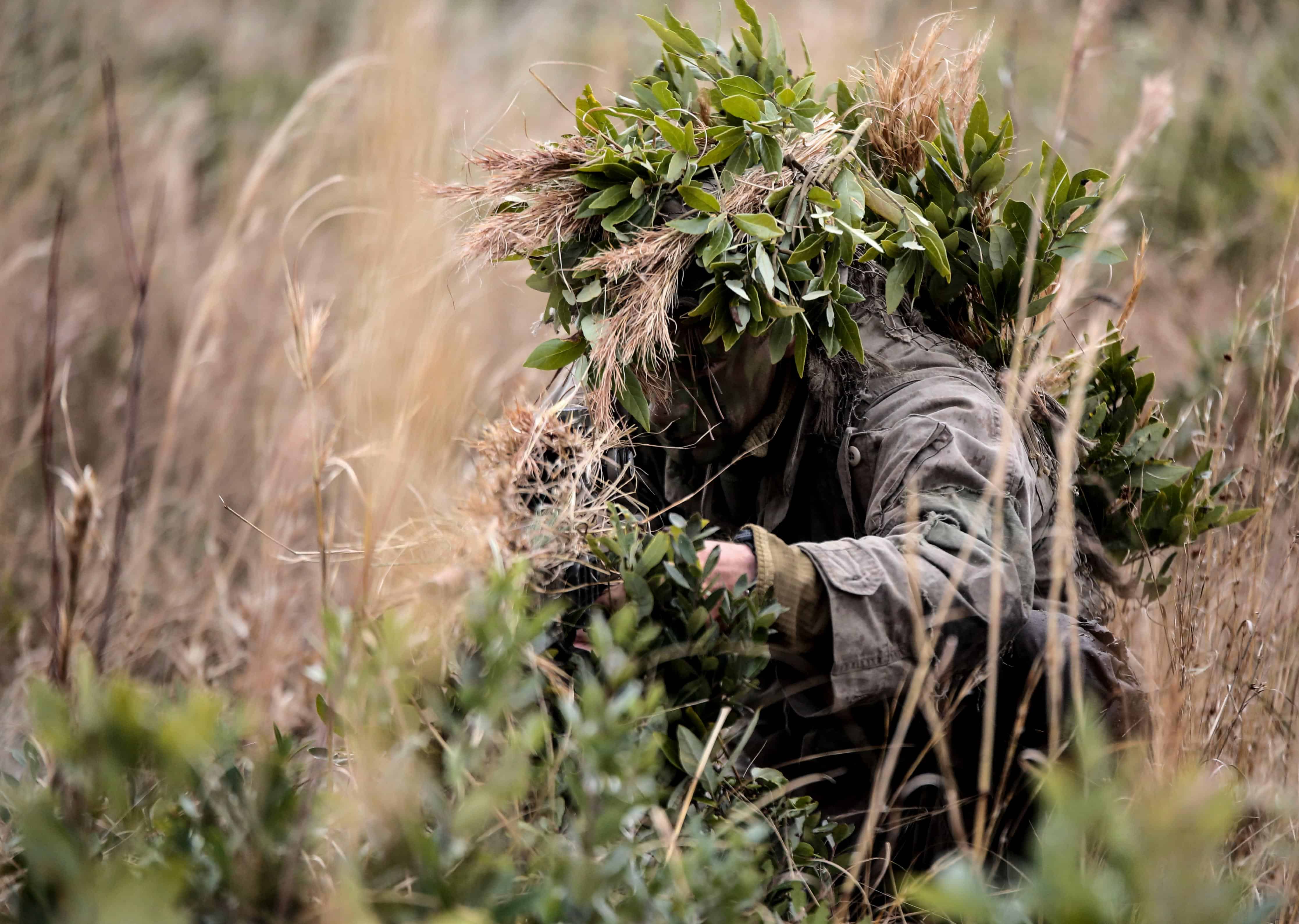 A Marine student undergoing the 2nd Marine Division Combat Skills Center’s Pre-Scout Sniper Course prepares to move during a stalking exercise at Camp Lejeune, N.C., Jan. 22, 2016. The exercise required students to traverse approximately 1,000 meters of high grass and fire on a target, all without being detected. (U.S. Marine Corps photo by Cpl. Paul S. Martinez/Released)