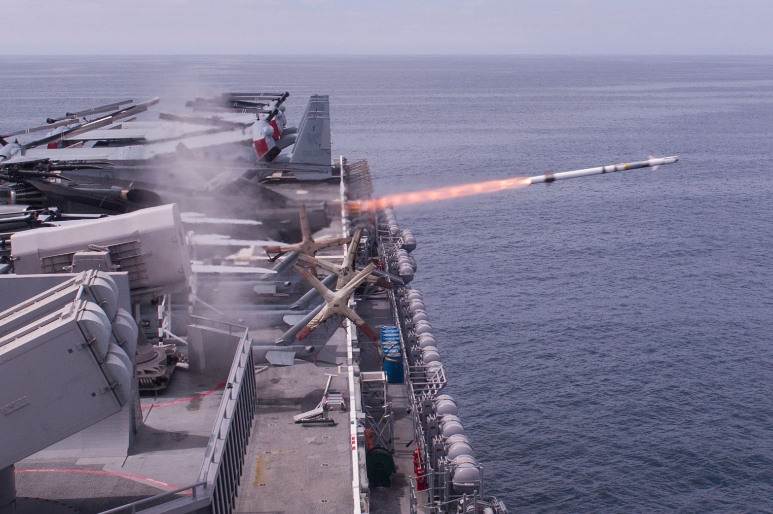 A rolling airframe missile (RAM), a surface-to-air intercept missile, launches from amphibious assault ship USS America (LHA 6), during a live-fire missile exercise off the coast of California.