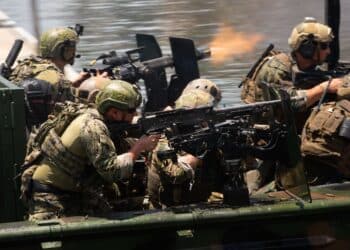 Multinational Special Operations Forces conduct an amphibious assault from a Special Operations Craft – Riverine boat during a capabilities demonstration as part of the 2018 International Special Operations Forces week in downtown Tampa, Fla., May 23, 2018. ISOF is the premier conference for the SOF community to advance the understanding of international SOF challenges. (Photo by U.S. Air Force Master Sgt. Barry Loo)