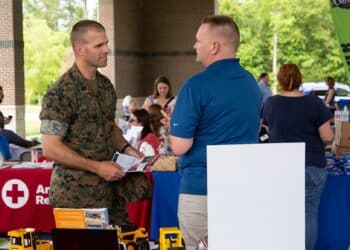 U.S. Marine Corps Sgt. Maj. Dustin Nelson, sergeant major, Wounded Warrior Battalion-East, meets with different booths raising awareness for post-traumatic stress disorder during the Lin Weidow Memorial, Camp Lejeune, N.C., May 24, 2018. Members of WWBn-E memorialized a cherished colleague, known for her outstanding dedication in helping recovering service members and having a positive impact on her peers. (U.S. Marine Corps photo by Lance Cpl. Ashley Gomez)