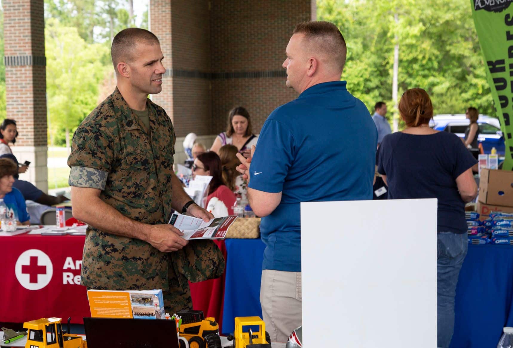 U.S. Marine Corps Sgt. Maj. Dustin Nelson, sergeant major, Wounded Warrior Battalion-East, meets with different booths raising awareness for post-traumatic stress disorder during the Lin Weidow Memorial, Camp Lejeune, N.C., May 24, 2018. Members of WWBn-E memorialized a cherished colleague, known for her outstanding dedication in helping recovering service members and having a positive impact on her peers. (U.S. Marine Corps photo by Lance Cpl. Ashley Gomez)