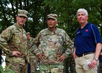 Governor Rick Snyder, Major General Gregory Vadnais, and Sergeant Major of the Army Dan Dailey look over the horizon of one of Camp Grayling, Michigan's live-fire ranges after witnessing soldiers from the 126th Infantry Regiment lay down support-by-fire as part of a training event for Distinguished Visitors Day August 15, 2018.