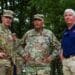 Governor Rick Snyder, Major General Gregory Vadnais, and Sergeant Major of the Army Dan Dailey look over the horizon of one of Camp Grayling, Michigan's live-fire ranges after witnessing soldiers from the 126th Infantry Regiment lay down support-by-fire as part of a training event for Distinguished Visitors Day August 15, 2018.