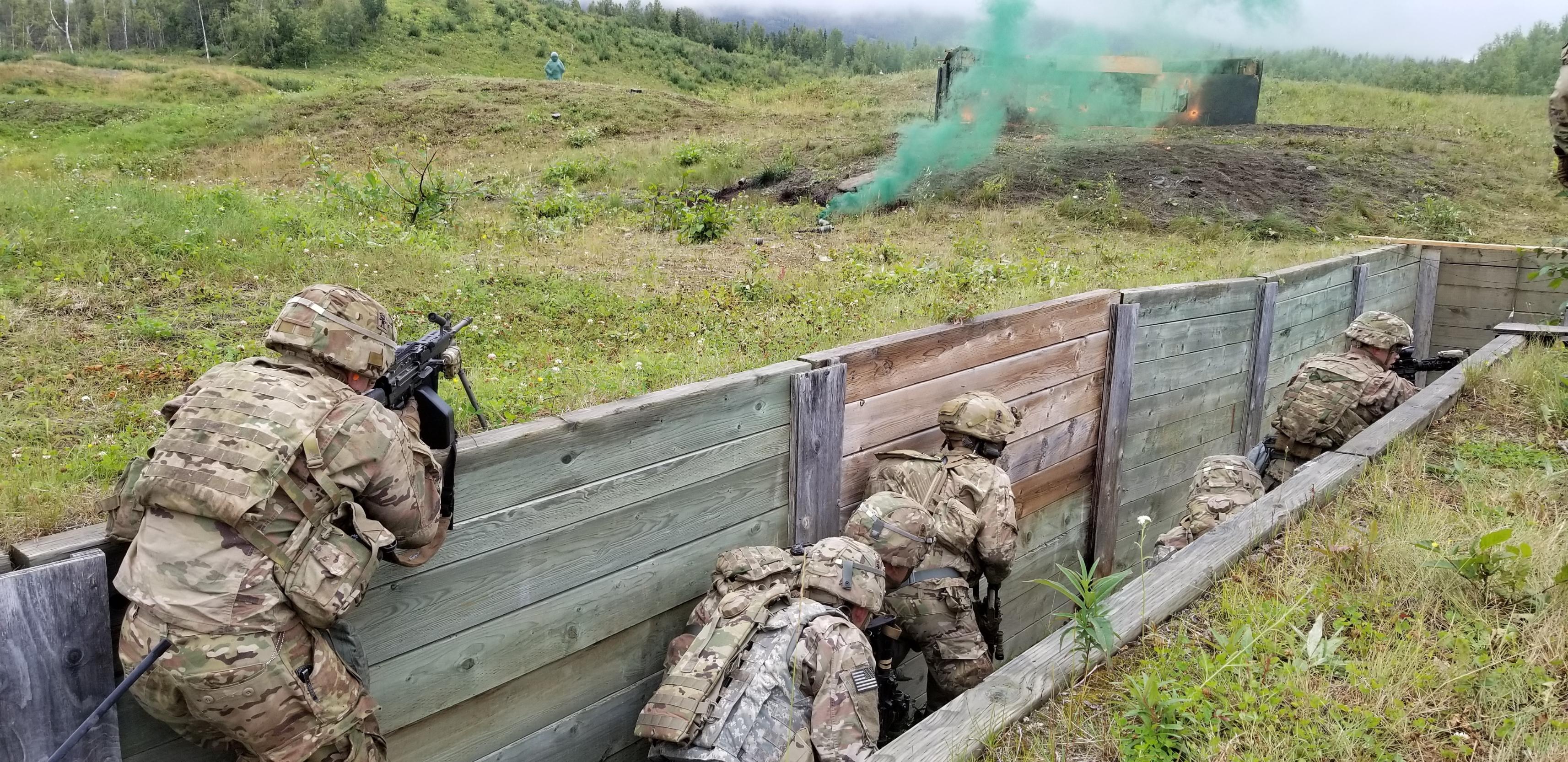 Paratrooper with 3rd Battalion, 509th Parachute Infantry Regiment, move through a trench as they assault a simulated bunker using the "SOSRA" technique 15 Aug., 2018, at Joint Base Elmendorf-Richardson. SOSRA is an acronym for Suppress, Obscure, Secure, Reduce, Assault. The terms describe the steps paratroopers take to take down an enemy bunker.