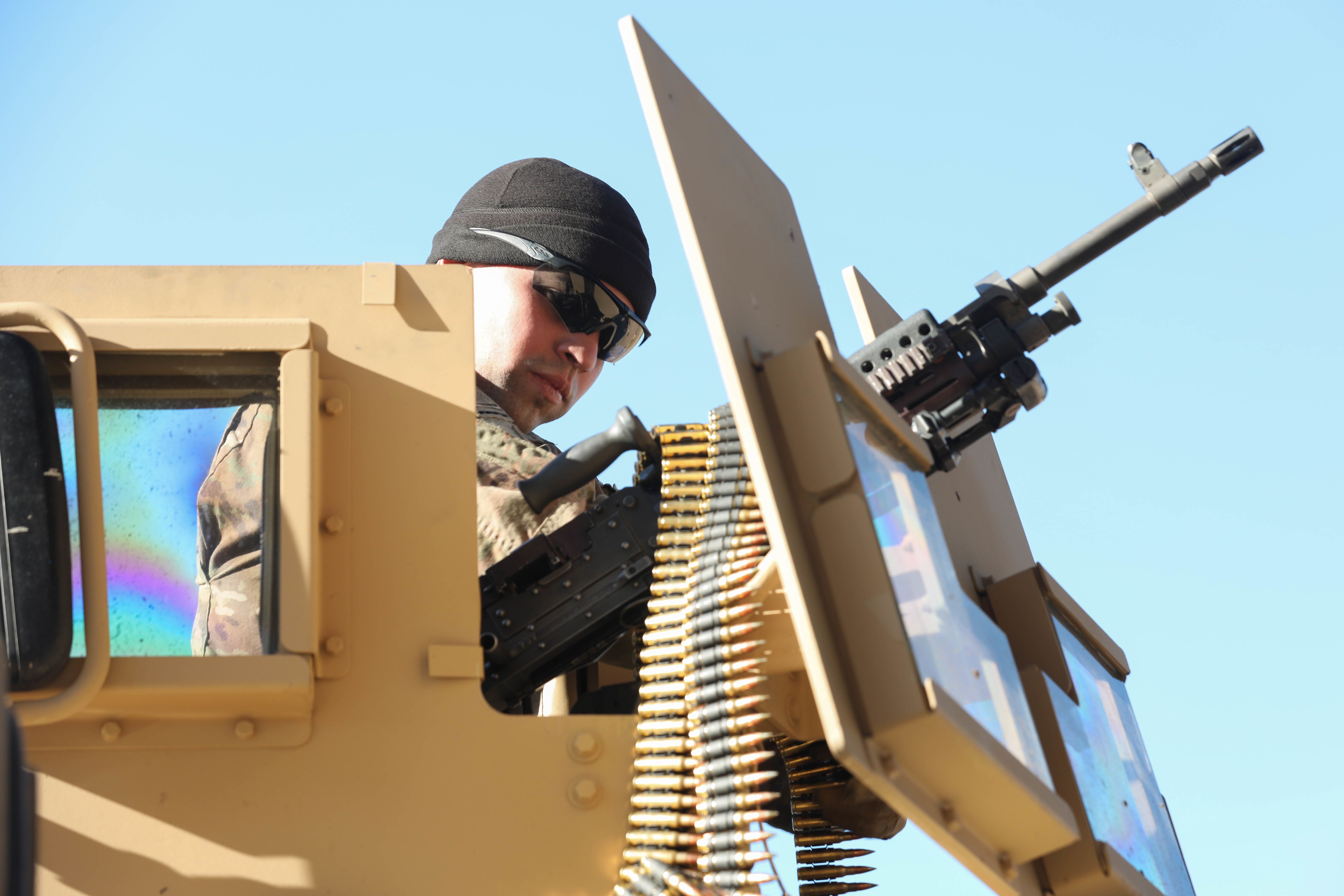 Sgt. Eric Roman, farrier with the Fort Carson Mounted Color Guard assigned to Headquarters and Support Company, Headquarters and Headquarters Battalion, 4th Infantry Division, loads ammunition into his crew's vehicle's overhead turret on Nov. 6, 2019, at Fort Carson. Roman controlled the overhead turret during HSC's gunnery training and shot pop-up targets as the rest of his team maneuvered the vehicle through the course. (U.S. Army photo by Pfc. Kelsey Simmons