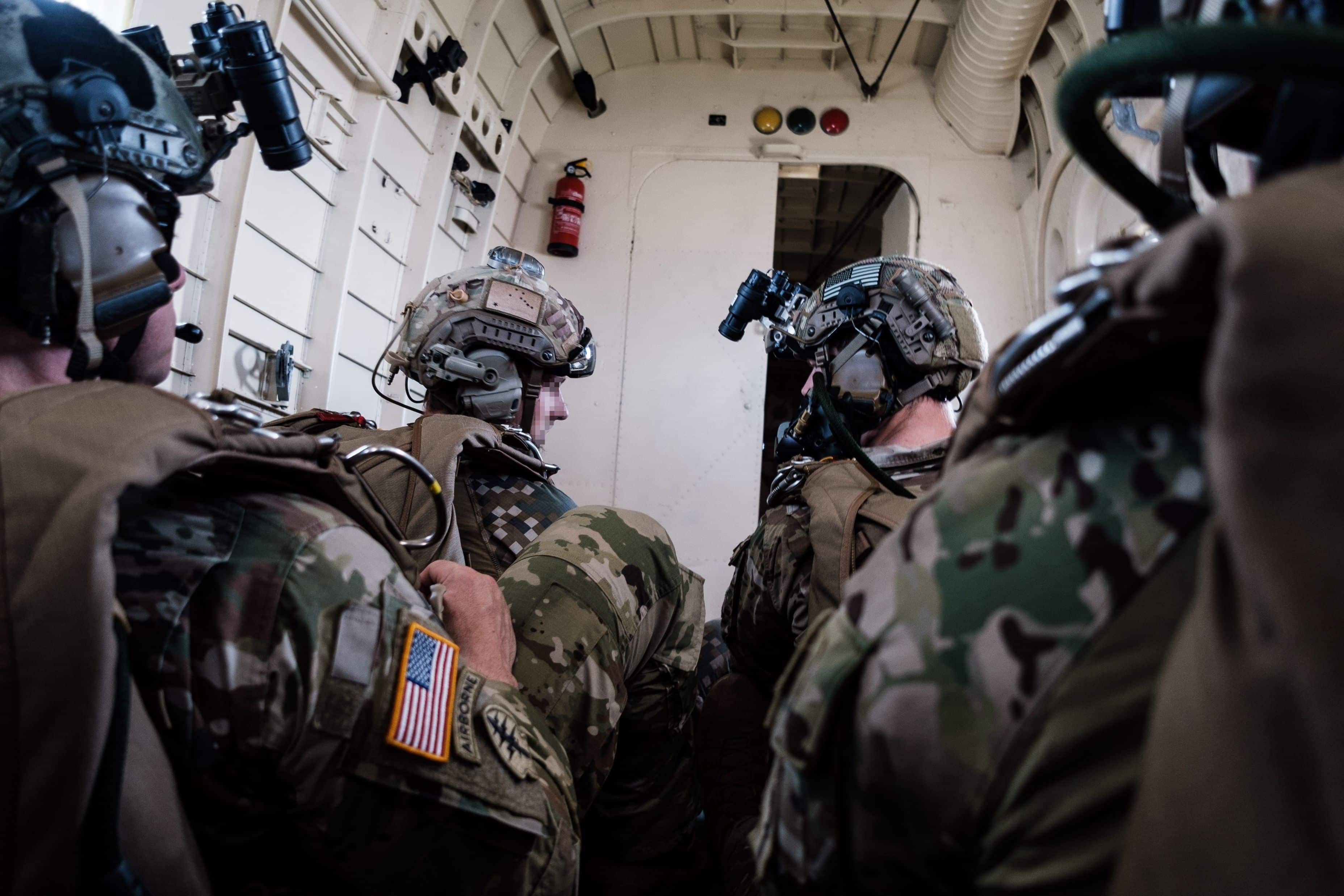 A Latvian Special Operations Unit operator, left, confers with his U.S. Army Special Forces counterpart prior to a high-altitude, low-opening jump over Latvia on 18 June 2020. The Latvian and U.S. Special Forces jumped from a Latvian Air Force Antonov AN-2 transport aircraft.