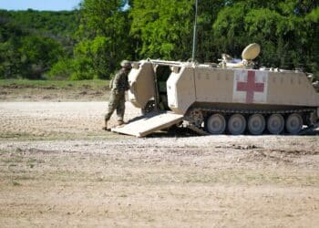 A Soldier with 1st Cavalry Division enters the M113 Ambulance during Warfighter 21-4 exercise at Fort Hood, Texas April 11, 2021. The M113 tracked ambulance has a capacity of: four litter casualties, or. ten ambulatory casualties, or. a mixed load of two litter casualties and five ambulatory casualties.(U.S. Army photo by Sgt. Melissa N. Lessard)