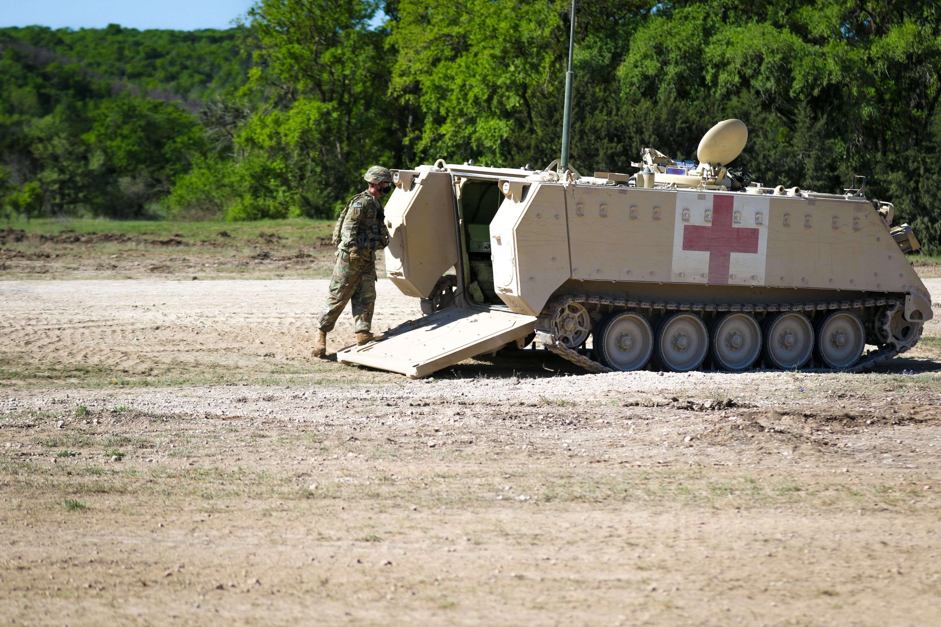 A Soldier with 1st Cavalry Division enters the M113 Ambulance during Warfighter 21-4 exercise at Fort Hood, Texas April 11, 2021. The M113 tracked ambulance has a capacity of: four litter casualties, or. ten ambulatory casualties, or. a mixed load of two litter casualties and five ambulatory casualties.(U.S. Army photo by Sgt. Melissa N. Lessard)