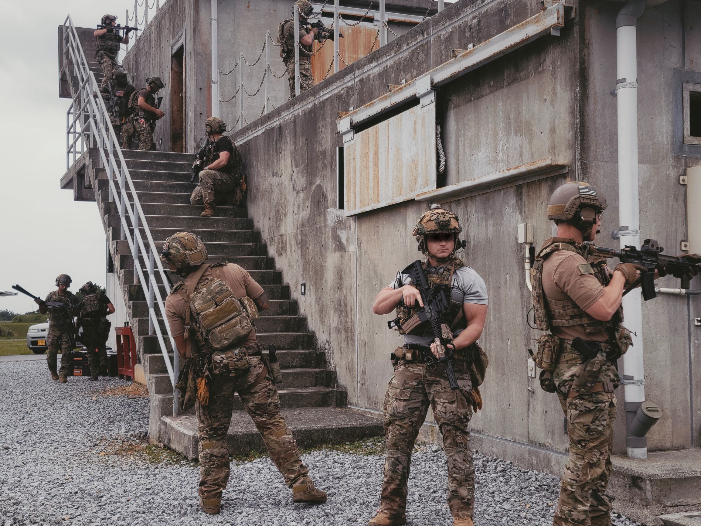 OKINAWA, Japan – Soldiers with 1st Battalion, 1st Special Forces Group (Airborne) and EOD Mobile Unit 5, breach a building during an assault on an objective, May 2021. Chemical, Biological, Radiological, Nuclear, and Explosives scenarios prepare the unit for contingency operations in the Pacific theatre. (U.S. Army Courtesy Photo by 1st Special Forces Group (Airborne)) (This photo has been altered for security purposes)