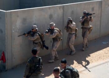 211107-M-PO838-1119 MALA NATIONAL TRAINING CENTER, Israel (Nov. 7, 2021) Marines assigned to Alpha Company, Battalion Landing Team 1/1, 11th Marine Expeditionary Unit move down a street in an urban training facility during an Israel interoperability exercise at Mala National Training Center, Israel, Nov. 7.