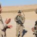 1st Lt. Matthew Fitzsimmons, platoon leader, Bravo Company, 4th Battalion, 9th Infantry Regiment, 1st Stryker Brigade Combat Team, 4th Infantry Division speaks with Spc. Ahmad Ali Khalaf, an Iraqi soldier stationed at a perimeter outpost at Al Asad Air Base on Dec. 21 2021