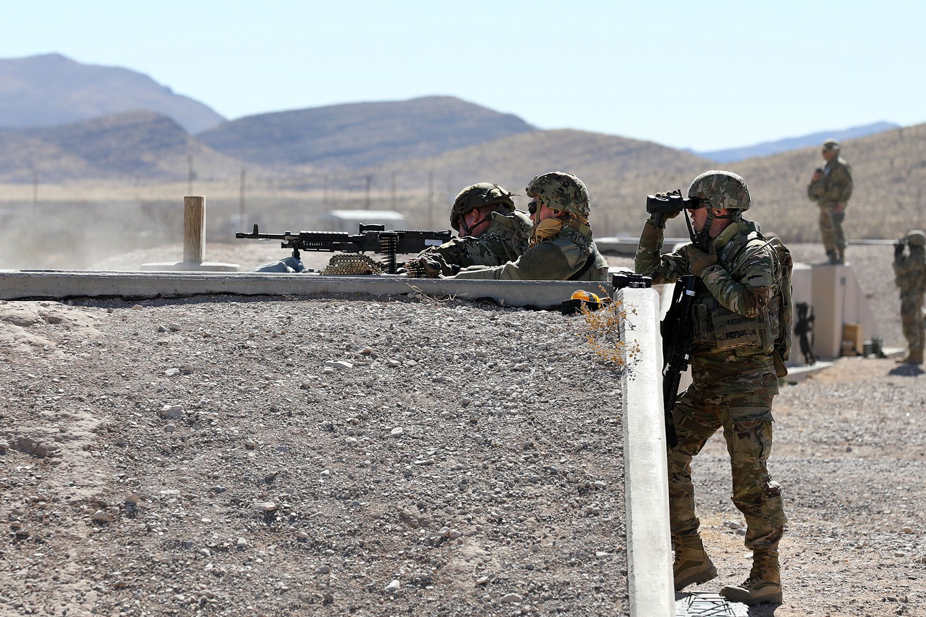 An M240 machine gun team from the 268th Military Police Company, of the Tennessee National Guard fires at targets, while observed by observer coach/trainers assigned to the 3-360th Training Support Battalion, during a range training exercise at Fort Bliss, Texas. The training focused primarily on communications between the tower,