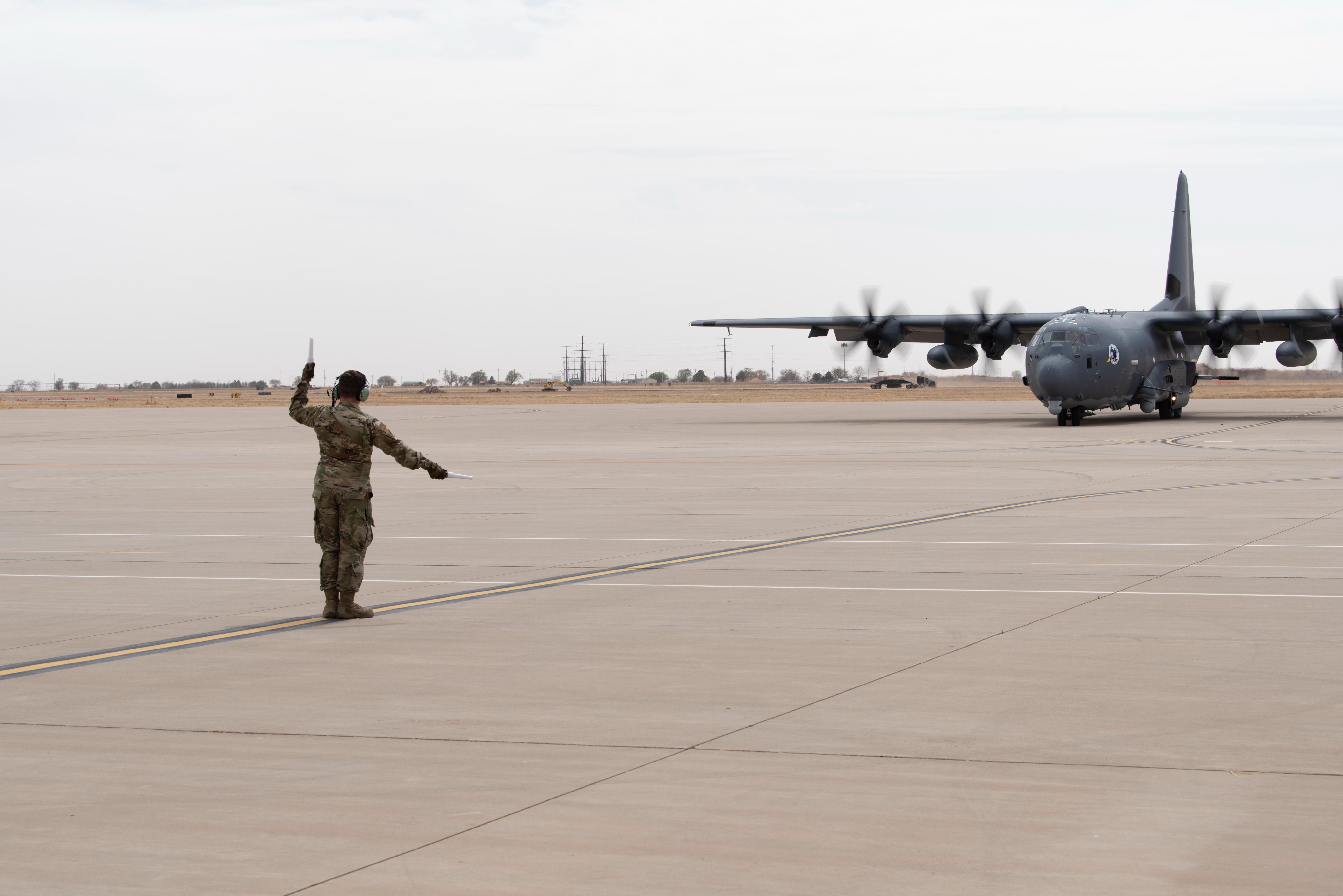 U.S. Air Force Airman 1st Class Jacob Sooter, 27th Special Operations Aircraft Maintenance Squadron crew chief, marshals the 16th Special Operations Squadrons first AC-130J Ghostrider aircraft at Cannon Air Force Base