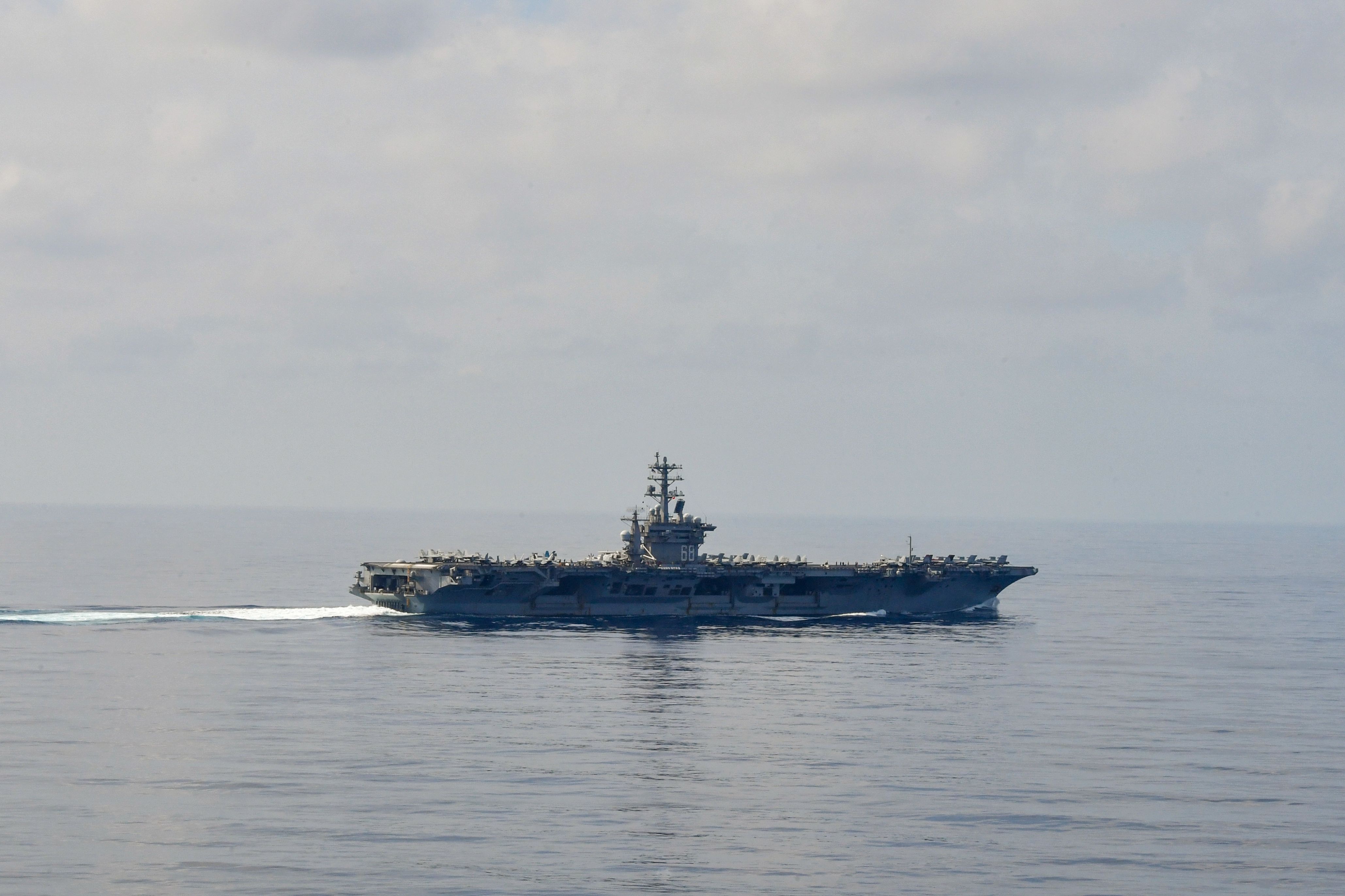 230115-N-BI507-1181 SOUTH CHINA SEA (Jan. 15, 2022) The aircraft carrier USS Nimitz (CVN 68) steams through the South China Sea. Nimitz in U.S. 7th Fleet conducting routine operations. 7th Fleet is the U.S. Navy's largest forward-deployed numbered fleet, and routinely interacts and operates with Allies and partners in preserving a free and open Indo-Pacific region. (U.S. Navy photo by Mass Communication Specialist 3rd Class Carson Croom)