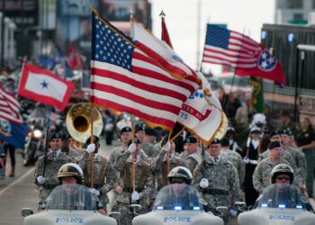 Soldiers assigned to the 101st Airborne Division (Air Assault) Honor Guard of Fort Campbell, Ky., lead the 2012 Veterans Day parade in downtown Nashville, Tenn. Thousands of veterans took part in the event which was the largest in the state. Some were on horseback, others were on motorcycles or in classic cars. Along the streets, people were lined up with their American flags and signs of support for the military. (U.S. Army Photo by Staff Sgt. Russell Lee Klika 118th MPAD)