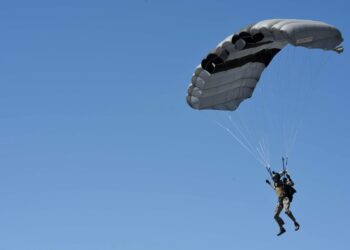 A Survival, Evasion, Resistance and Escape (SERE) Specialist, from the 22nd Training Squadron, safely parachutes to the flightline during training at Fairchild Air Force Base, Washington May 31, 2023. Parachuting is an integral part of SERE training that ensures the readiness of the Airmen who go through the course. (U.S. Air Force photo by Airman 1st Class Clare Werner)