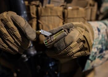 U.S. Marine Corps Lance Cpl. Tyler Hallman, a low altitude air defense gunner with 3d Littoral Anti-Air Battalion, 3d Marine Littoral Regiment, 3d Marine Division, fills a magazine with ammunition during a short distance live-fire range at Marine Corps Base Hawaii, August 10, 2023. The purpose of this exercise is to increase the LAAB’s proficiency with close contact engagement and maintain combat readiness. (U.S. Marine Corps photo by Lance Cpl. Malia Sparks)