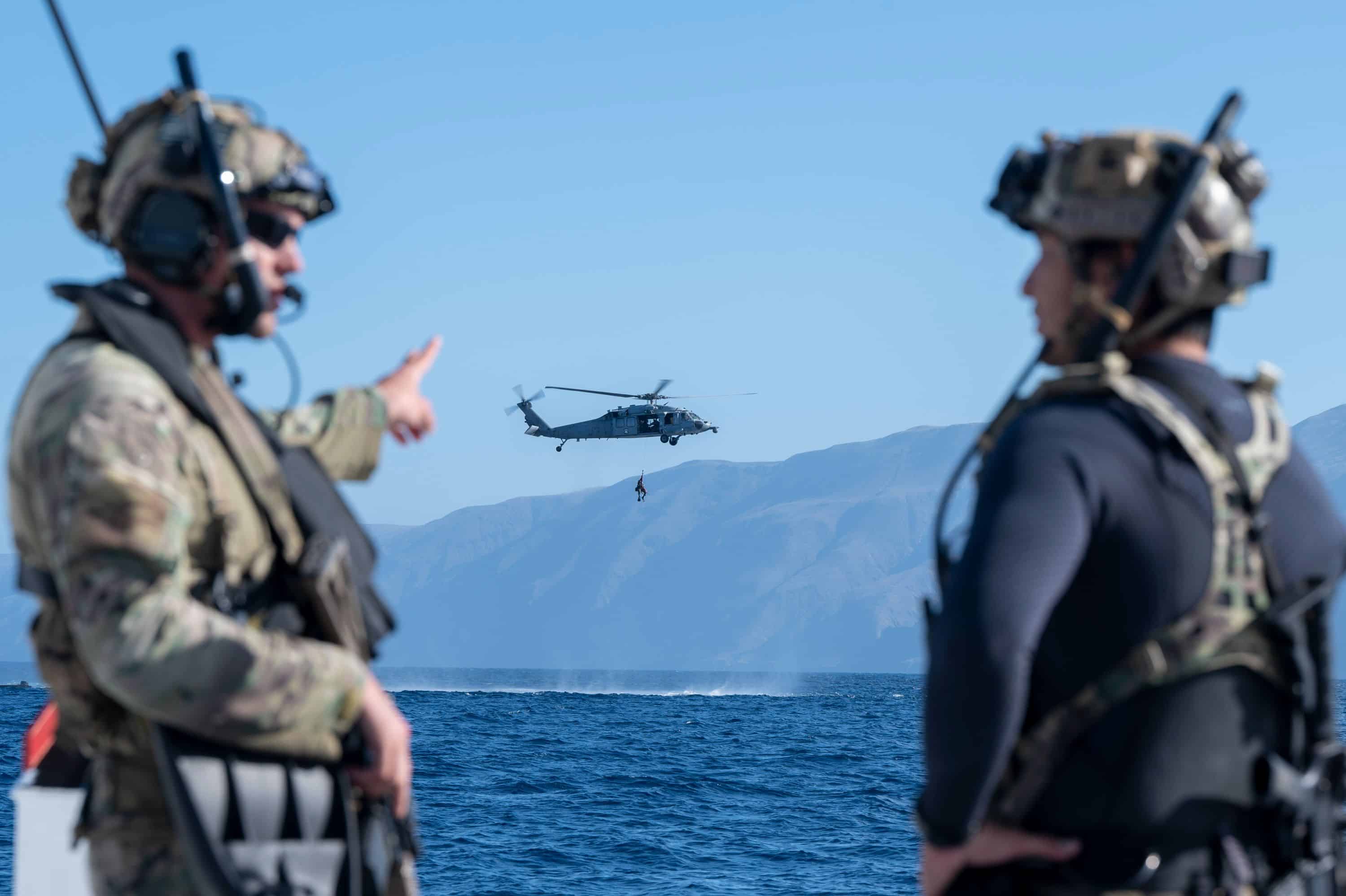 U.S. Airmen, training with the 68th Rescue Squadron, discuss mission objectives off the coast of Calif., Sept. 13, 2023. The Airmen lead their team in the treating and exfiltration of several simulated casualties. (U.S. Air Force photo by Airman 1st Class William Finn V)