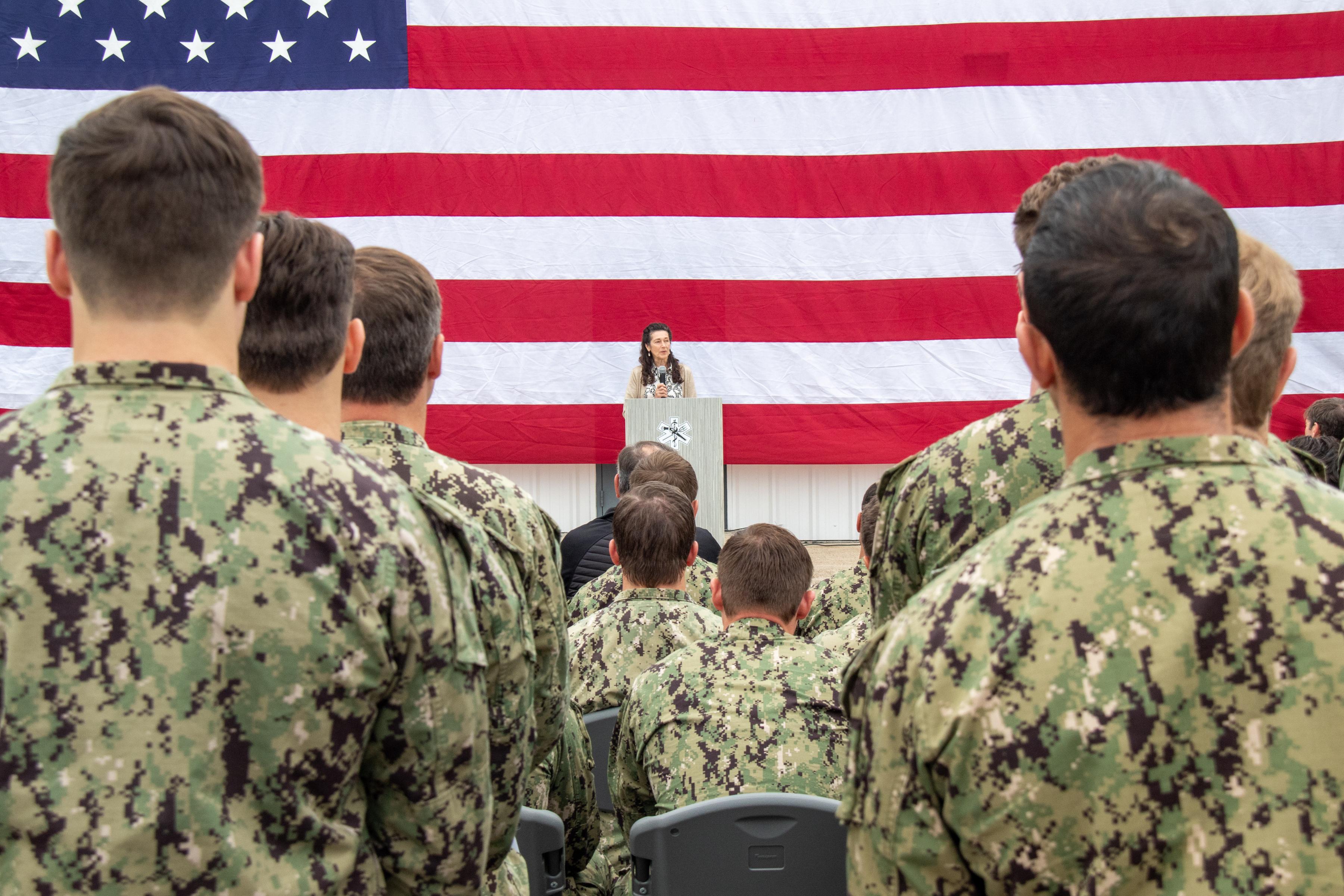 231117-N-LW994-1125 STENNIS SPACE CENTER, Miss. (Nov. 17, 2023) Charlie Ebbert, mother of deceased U.S. Navy Special Warfare Operator 1st Class Kevin Ebbert, gives a speech in memory of her son during a ceremony to dedicate the quarterdeck of the Special Operations Tactical Medicine schoolhouse at John C. Stennis Space Center