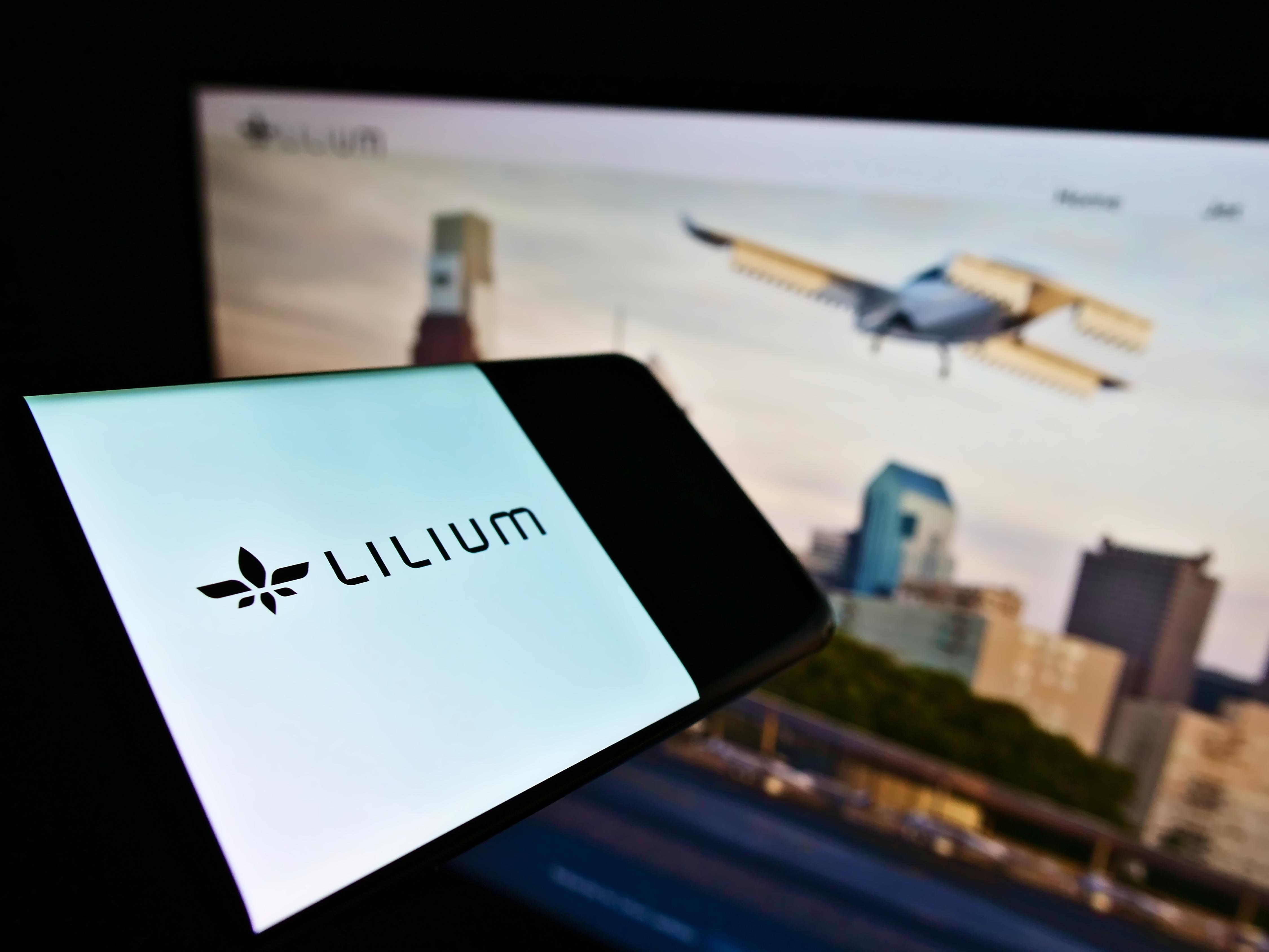 Stuttgart, Germany - 02-26-2021: Cellphone with company logo of German airplane manufacturer Lilium GmbH (Lilium Jet) on screen in front of website. Focus on center of phone display. Unmodified photo.