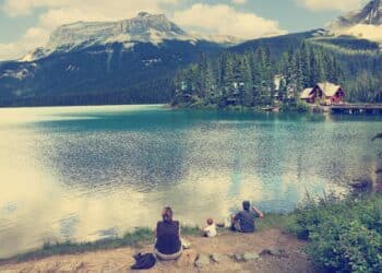 Family on the bank of Emerald lake (Yoho National park. Alberta. Canada) Image done with a vintage retro instagram filter