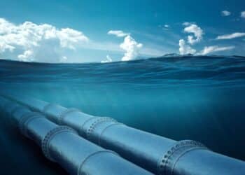 Gas pipeline under water, metal pipes at the bottom of the sea. The concept of oil pipeline, gas pipeline, gas transportation. copy space