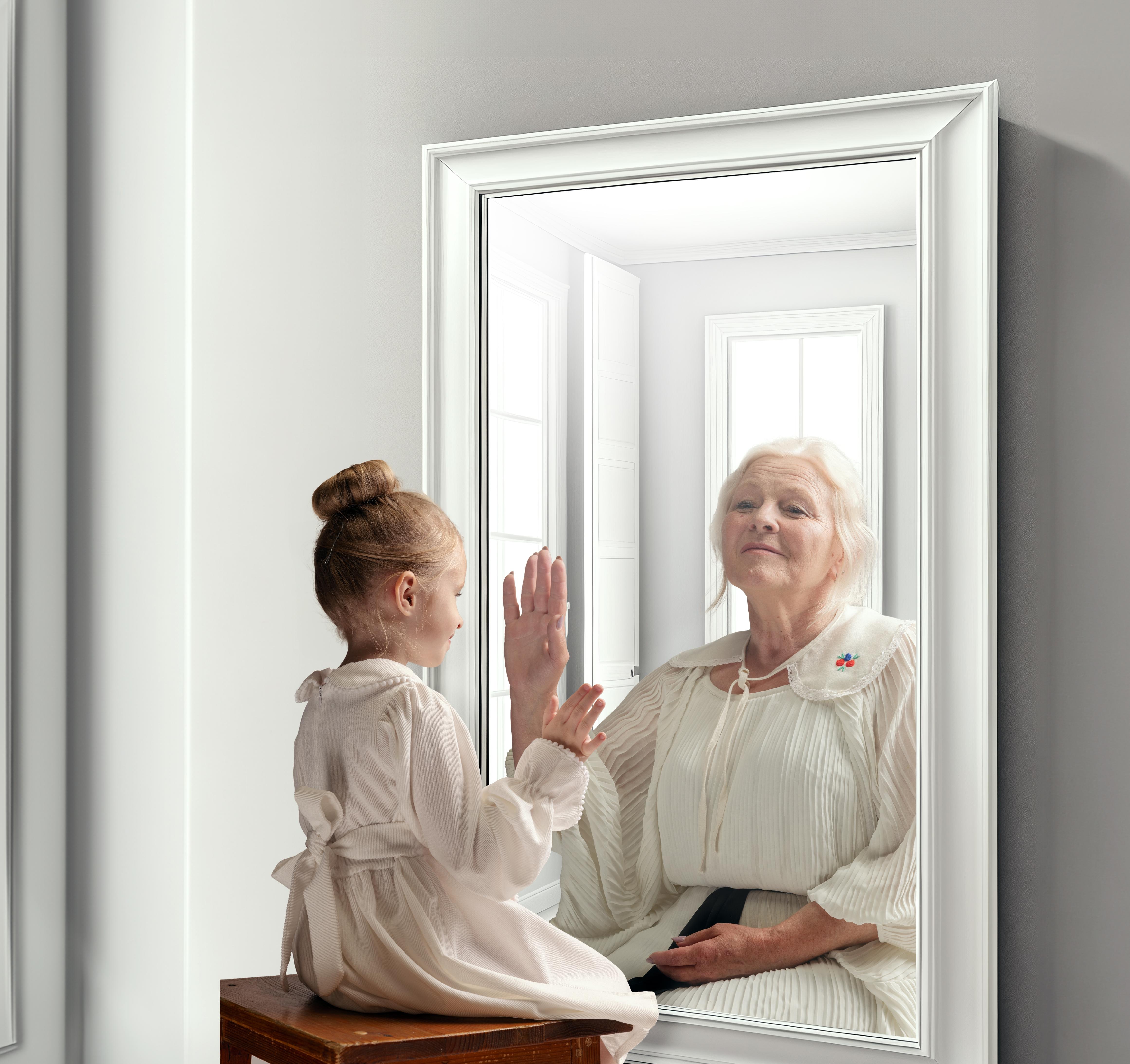 Creative conceptual collage. Little girl looking in mirror and seeing reflection of senior lady. Her future self. Child and grandmother. Concept of present, past and future, age, lifestyle, generation