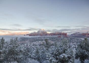 Looking north across Sedona covered with snow towards Thunder Mountain aka Capitol Butte just after dawn. Horizontal image with copy space and crisp, clear winter light.