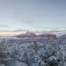 Looking north across Sedona covered with snow towards Thunder Mountain aka Capitol Butte just after dawn. Horizontal image with copy space and crisp, clear winter light.