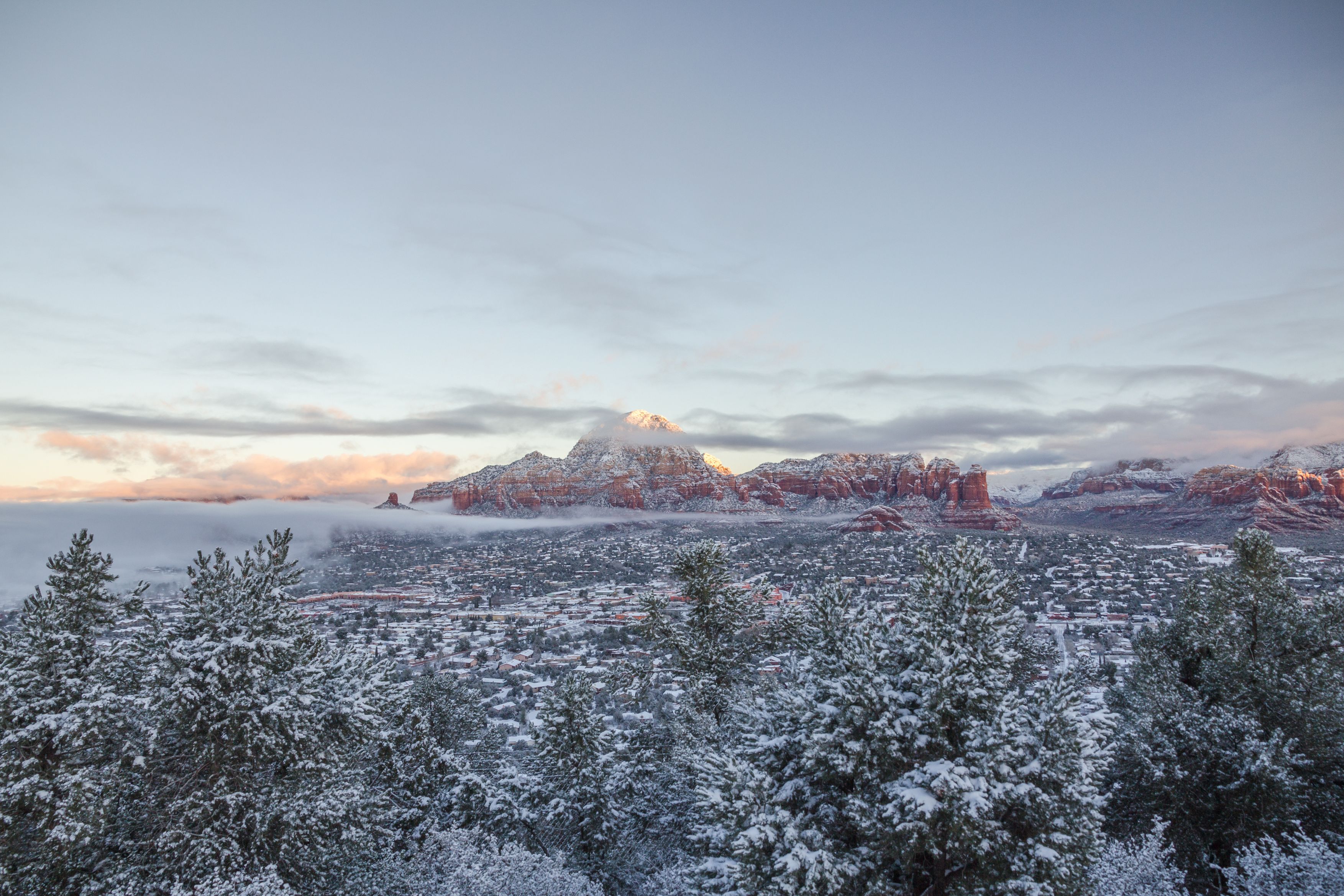 Looking north across Sedona covered with snow towards Thunder Mountain aka Capitol Butte just after dawn. Horizontal image with copy space and crisp, clear winter light.