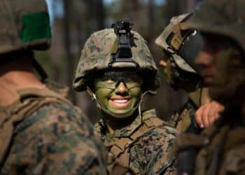 Pfc. Christina Fuentes Montenegro, of Coral Springs, Fla., and other Marines from Delta Company, Infantry Training Battalion, School of Infantry-East, receive final instructions prior to assaulting an objective during the Infantry Integrated Field Training Exercise aboard Camp Geiger, N.C., Nov 15, 2013.