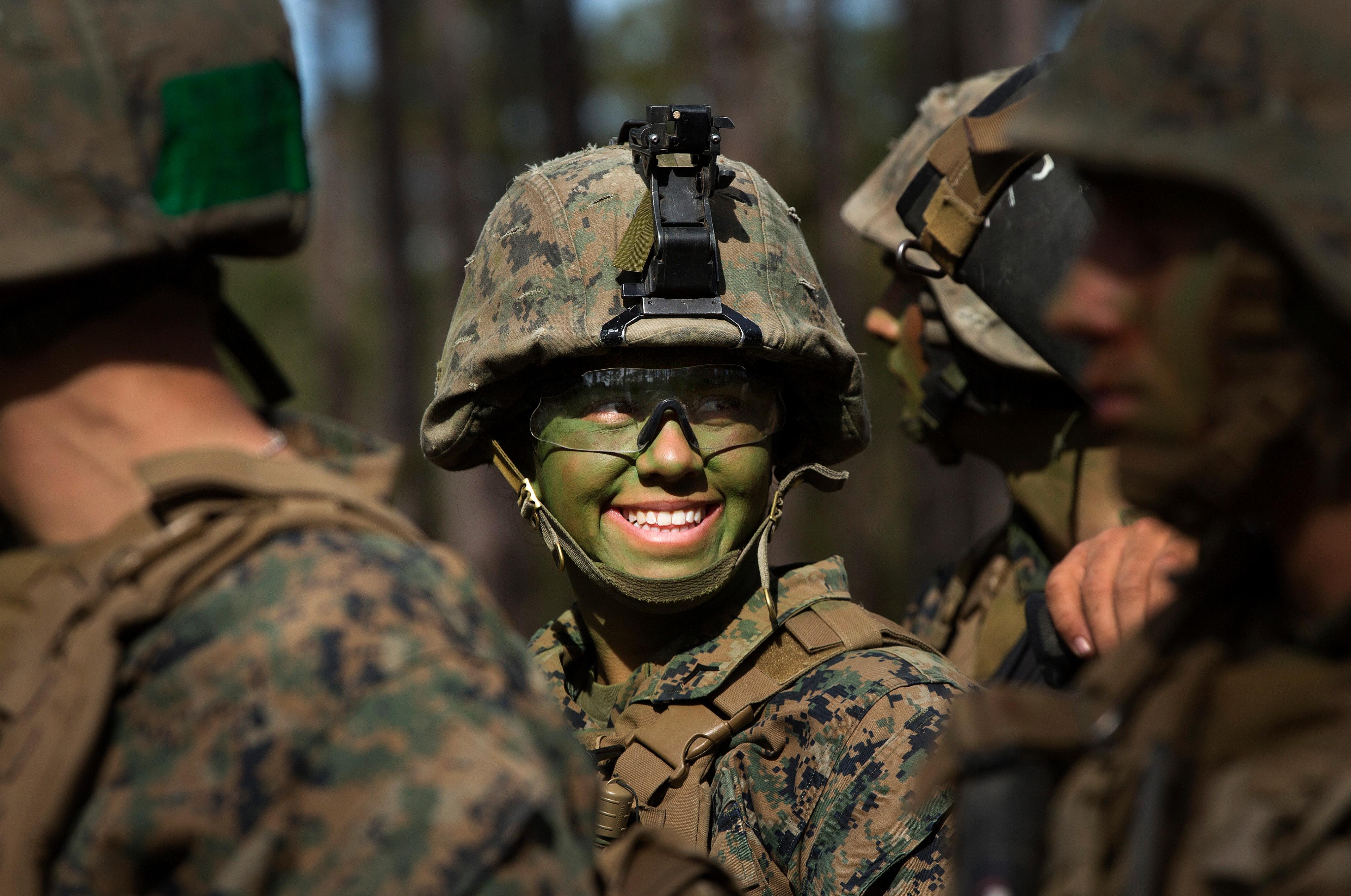 Pfc. Christina Fuentes Montenegro, of Coral Springs, Fla., and other Marines from Delta Company, Infantry Training Battalion, School of Infantry-East, receive final instructions prior to assaulting an objective during the Infantry Integrated Field Training Exercise aboard Camp Geiger, N.C., Nov 15, 2013.