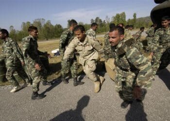 10/14/05 - U.S. Army and Pakistani Soldiers rush to unload U.S. medical supplies off a U.S. Army CH-47 Chinook helicopter in Islamabad, Pakistan, Oct. 14, 2005. The U.S. Army is delivering disaster relief supplies and services as part of a multinational effort to provide aid and support to Pakistan and parts of India and Afghanistan following a devastating earthquake. DoD photo by Tech. Sgt. Mike Buytas, U.S. Air Force. (Released)