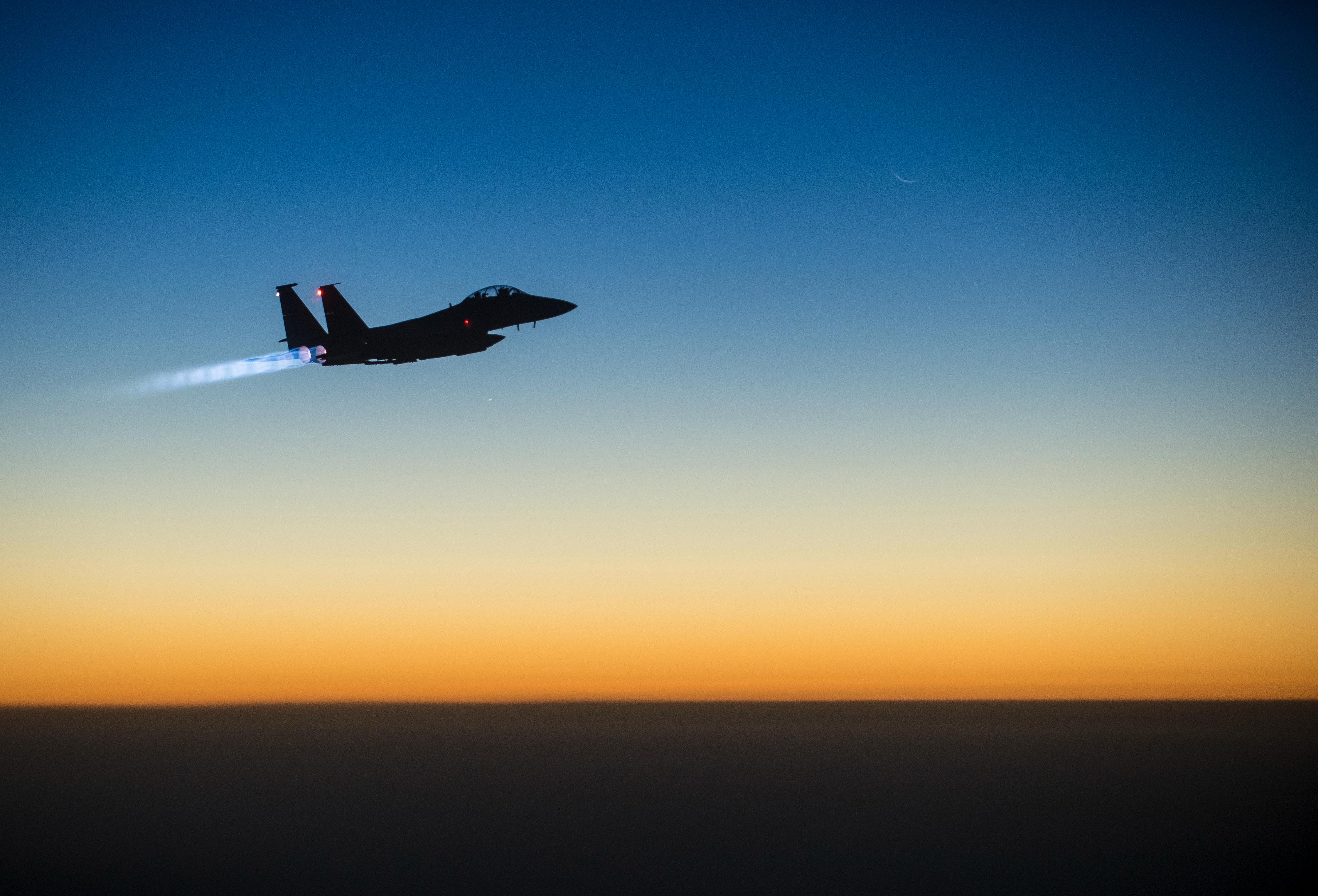 A U.S. Air Force F-15E Strike Eagle flies over northern Iraq early in the morning of Sept. 23, 2014, after conducting airstrikes in Syria. This F-15 was a part of a large coalition strike package that was the first to strike ISIL targets in Syria. (U.S. Air Force photo by Senior Airman Matthew Bruch/Released)