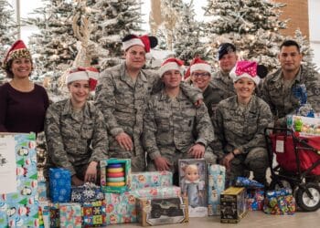 Volunteer Junior Enlisted Council Airmen from Will Rogers Air National Guard Base, Okla., pose with gifts ready to be delivered to children at INTEGRIS Baptist Health Center