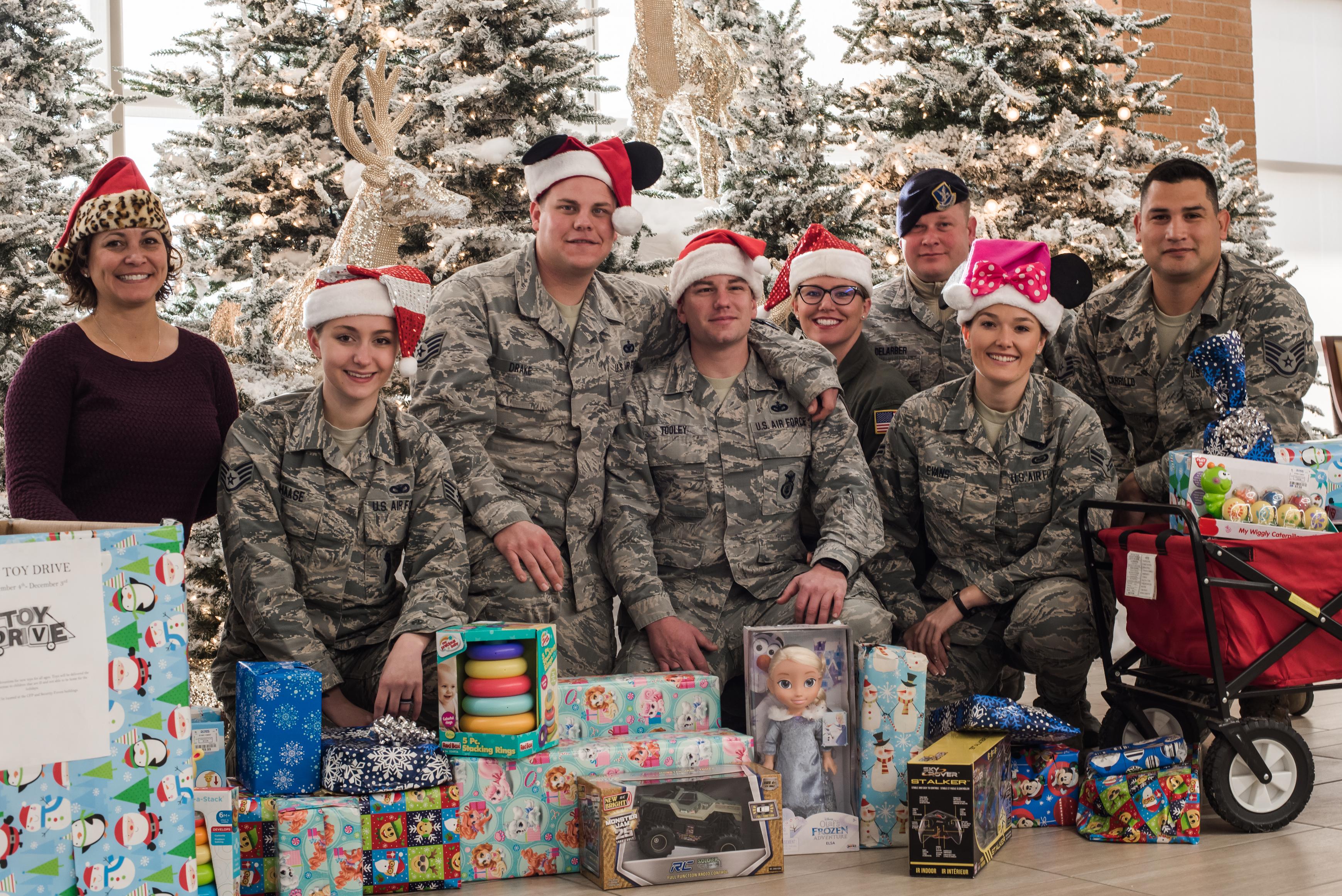 Volunteer Junior Enlisted Council Airmen from Will Rogers Air National Guard Base, Okla., pose with gifts ready to be delivered to children at INTEGRIS Baptist Health Center