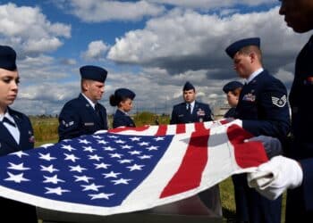 Ohio Air National Guard Master Sgt. Daniel Petry (center) oversees new Base Honor Guard Team members as they perform a flag-folding detail during training in October 2015 at Rickenbacker Air National Guard Base in Columbus, Ohio