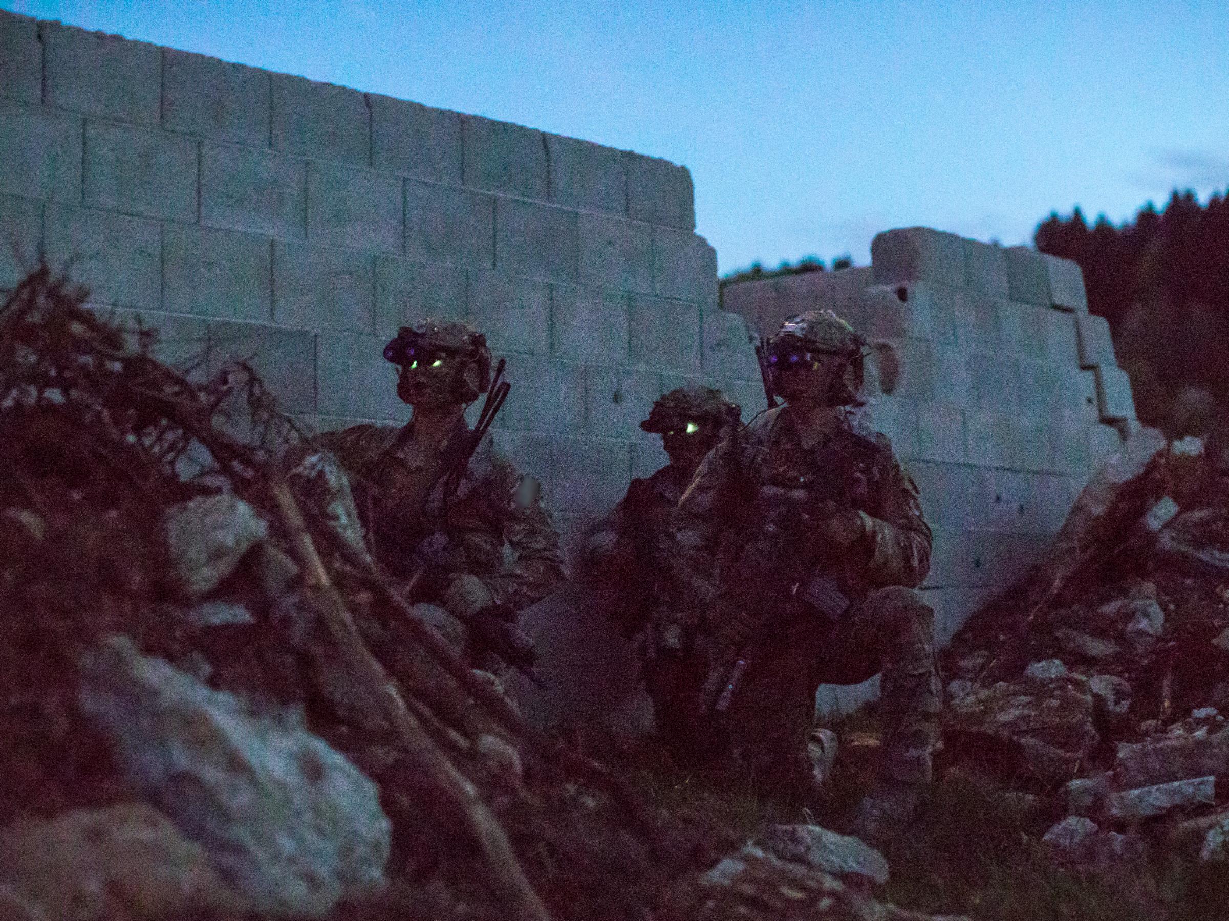 U.S. Army Rangers assigned to the 75th Ranger Regiment take cover behind piles of rubble while on a raid during the Joint Warfighter Assessment at the Joint Multinational Readiness Center in Hohenfels, Germany, April 25, 2018. The Joint Warfighter Assessment helps the Army evaluate emerging concepts, integrate new technologies, and promote interoperability of the U.S. and partner nations. (U.S. Army photo by 1st Lt. Benjamin Haulenbeek)