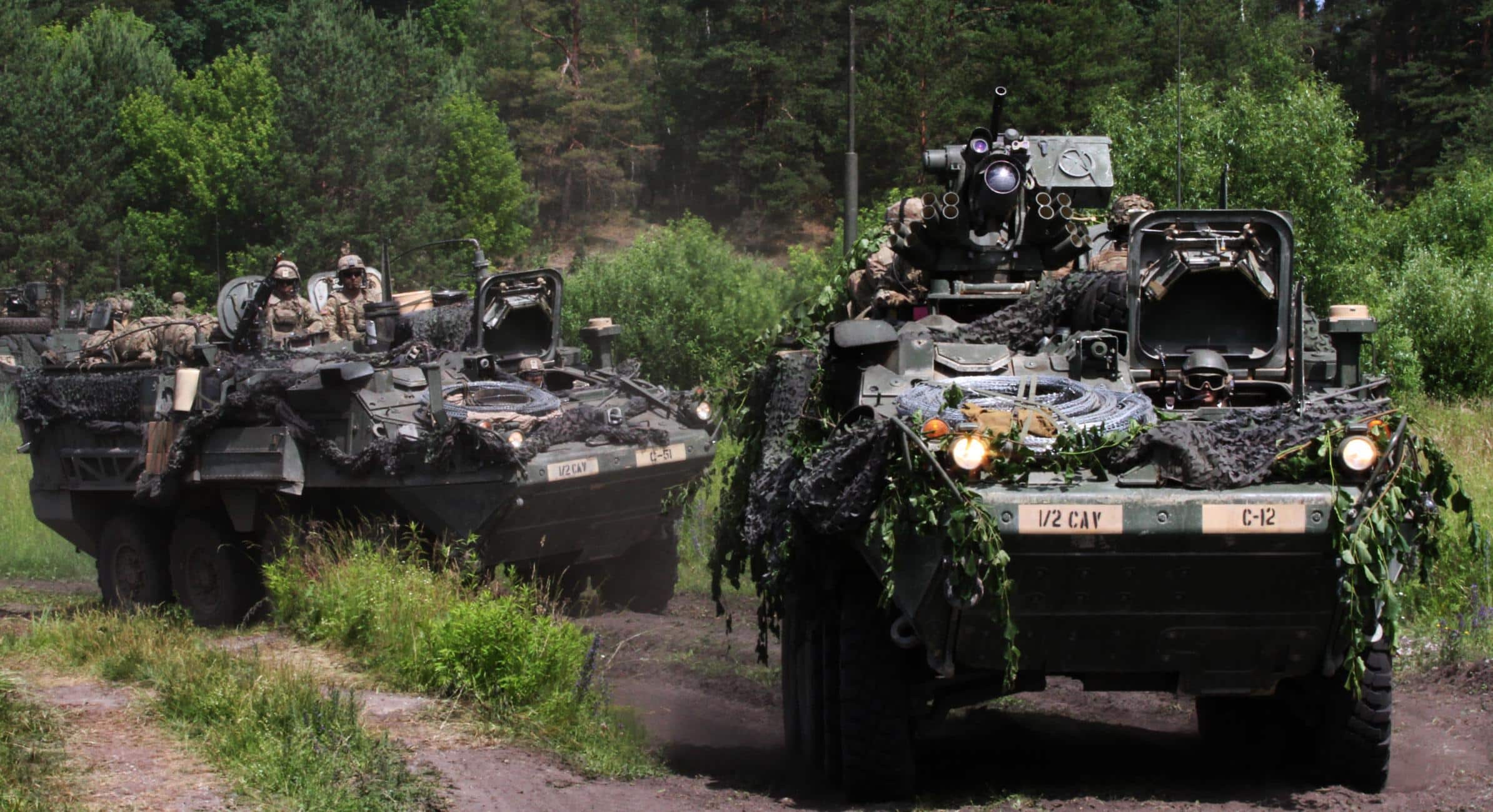 U.S. soldiers in Battle Group Poland drive a U.S. Army Interim Armored Vehicle Stryker around a water hazard at the Bemowo Piskie Training Area on June 5, 2018