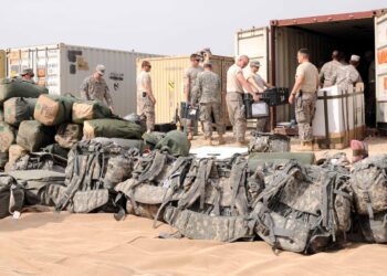 Duffel bags and assault packs are stacked in a pile as soldiers from Alpha Company, 3rd Brigade Special Troops Battalion, 1st Cavalry Division from Fort Hood, Texas, load equipment into a cargo container on Contingency Operating Base Adder, Oct. 28.