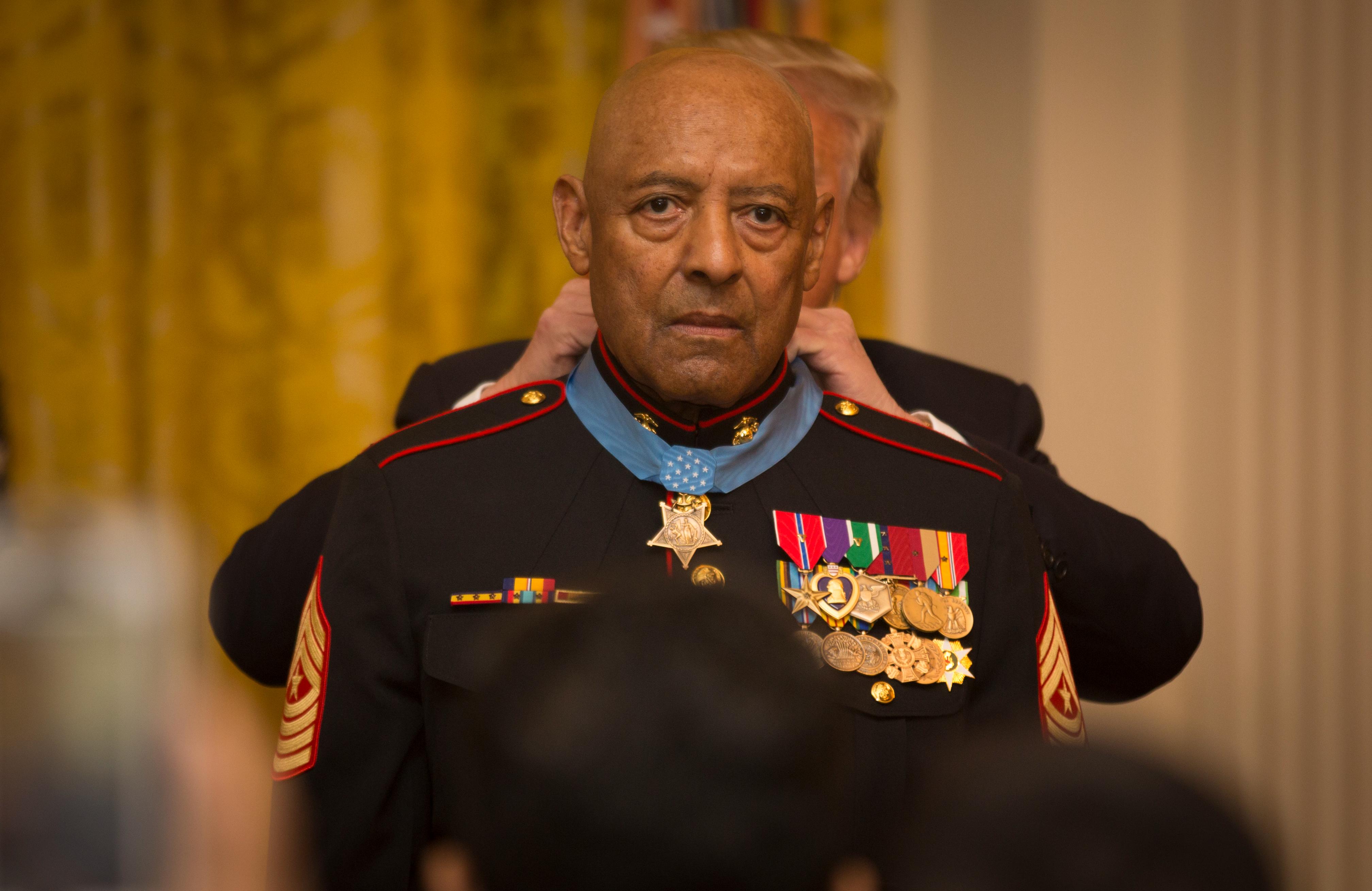 President of the United States Donald J. Trump places the Medal of Honor around retired U.S. Marine Corps Sgt. Maj. John L. Canley's neck, the 298th Marine Medal of Honor recipient, at the White House in Washington, D.C., Oct. 17, 2018. From Jan. 31, to Feb. 6, 1968
