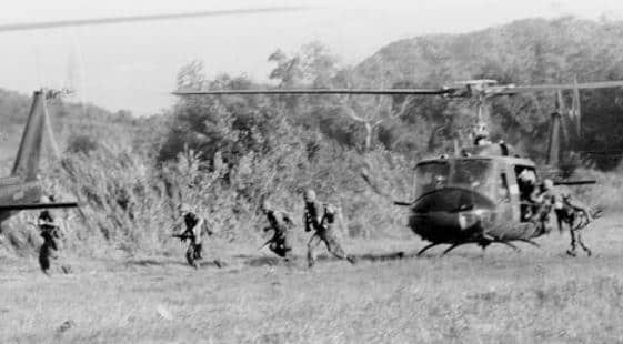 Soldiers with the Army’s 1st Cavalry Division disembark a UH-1 Iroquois helicopter in the Ia Drang Valley of Vietnam. Army photo