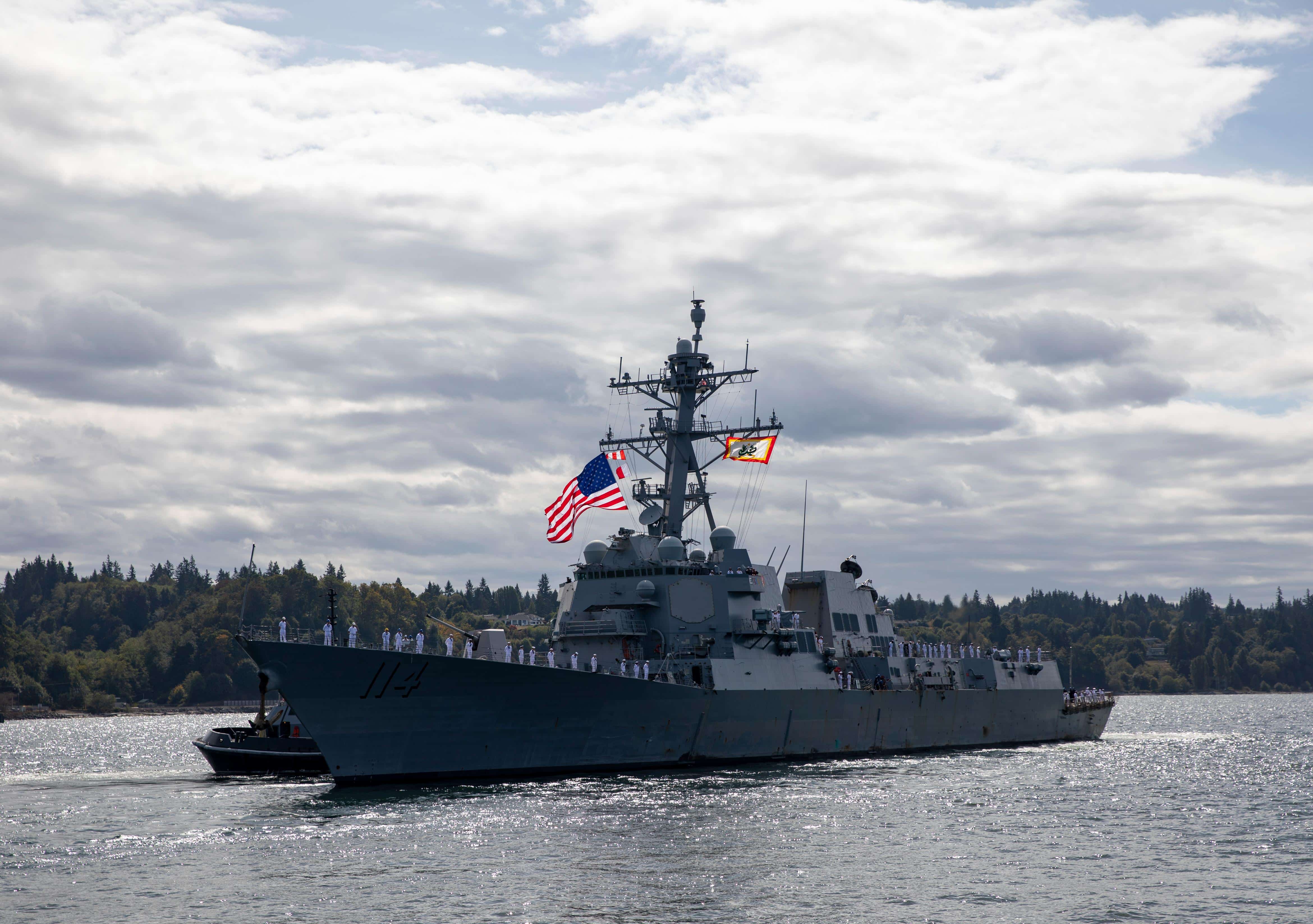 The Arleigh Burke-class guided-missile destroyer USS Ralph Johnson (DDG 114) departs Naval Station Everett, Sep. 15, 2021. The ship will forward-deploy to Japan to replace the guided-missile destroyer USS Mustin (DDG 89) that is scheduled for overhaul maintenance. (U.S. Navy photo by Mass Communication Specialist 2nd Class Ethan Soto)