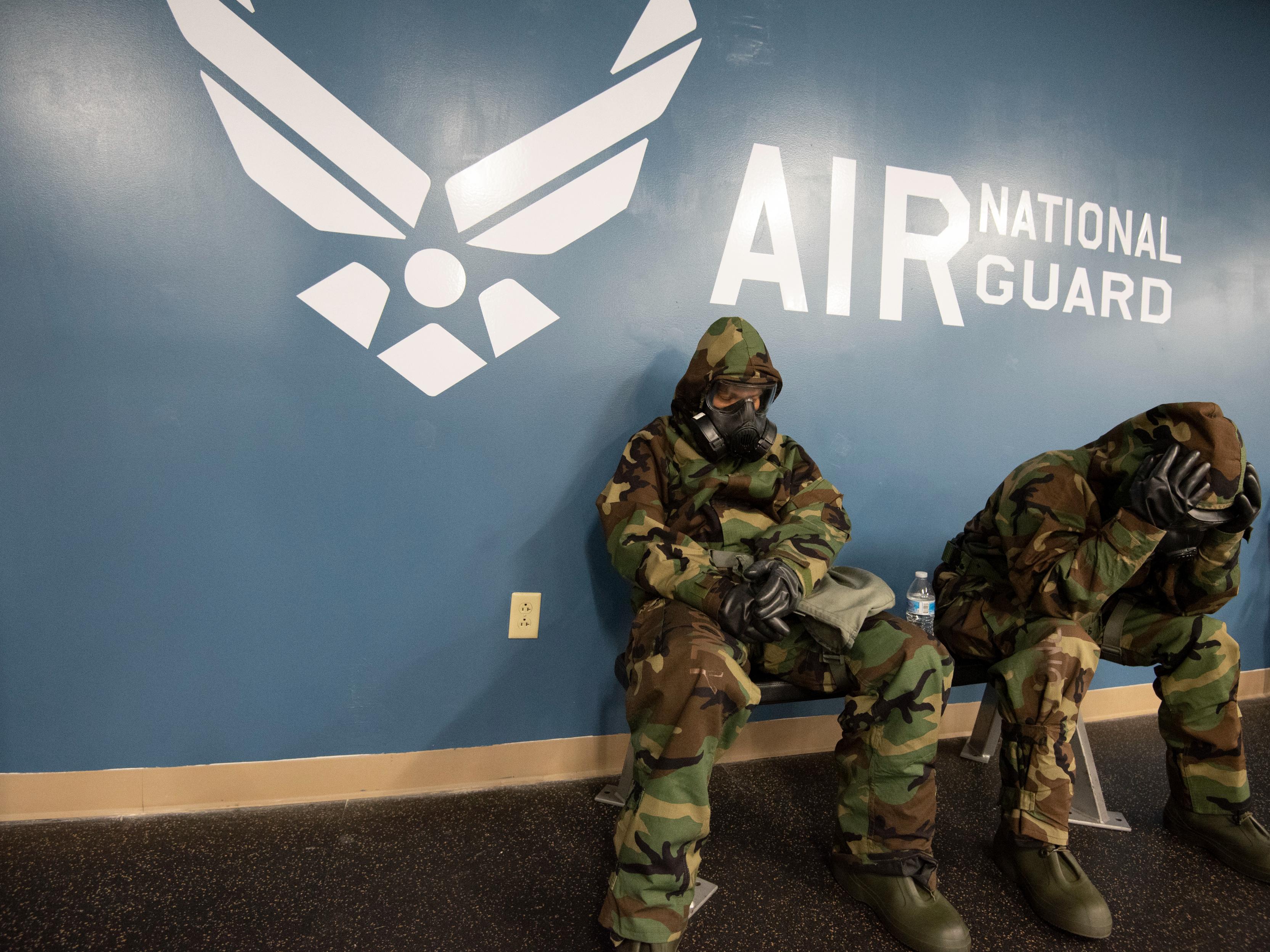 U.S. Air Force Staff Sgt. Wendy Kuhn, left, with the 121st Air Refueling Wing Public Affairs Office, awaits the "All Clear" while wearing an M50 gas mask during a Nuclear Operational Readiness Exercise, September 20, 2021, at Rickenbacker Air National Guard Base, Ohio. The NORE is to prepare Airmen for an upcoming Nuclear Operational Readiness Inspection (NORI). (U.S. Air National Guard photo by Tech Sgt. James Courtright)