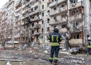 KYIV, UKRAINE - Feb. 25, 2022: War of Russia against Ukraine. A residential building damaged by an enemy aircraft in the Ukrainian capital Kyiv